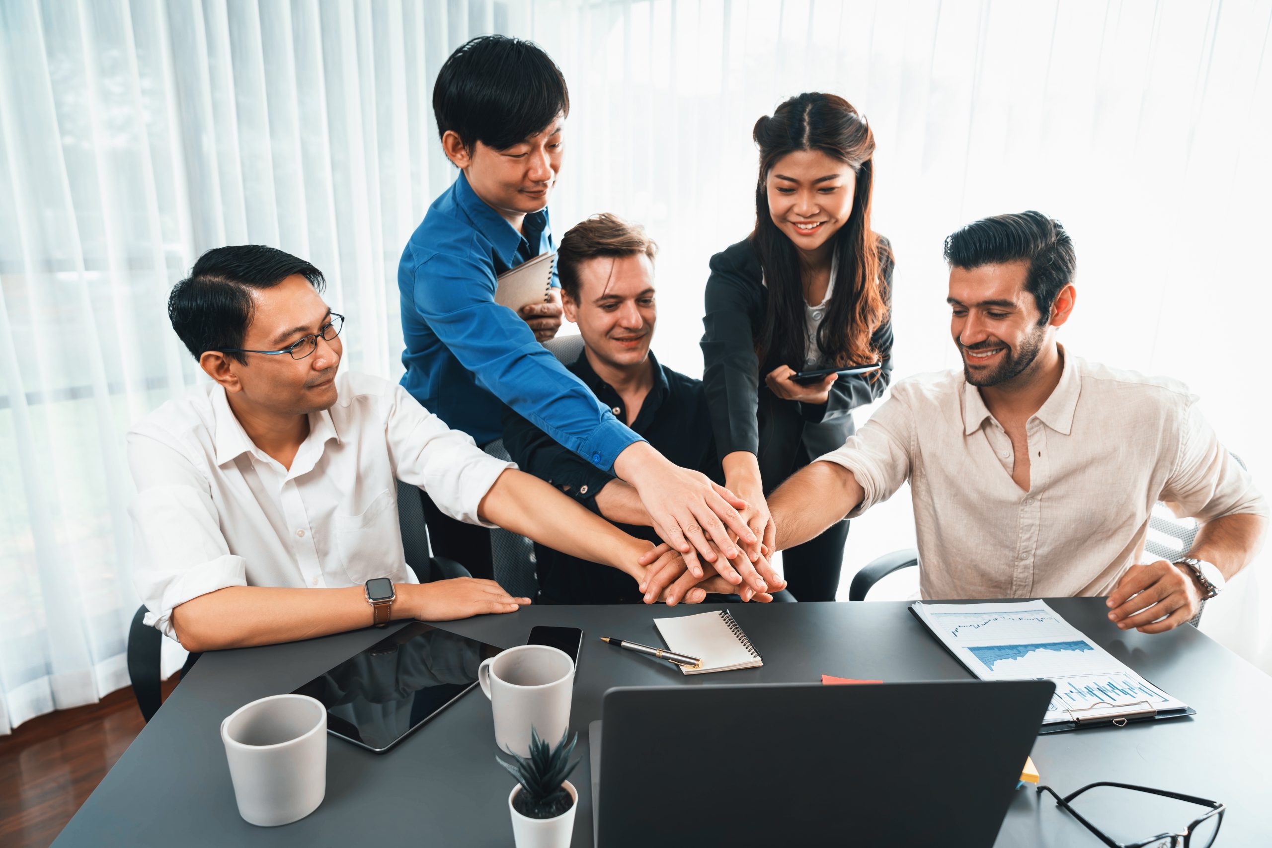 Group of diverse office worker join hand together in office. Prudent